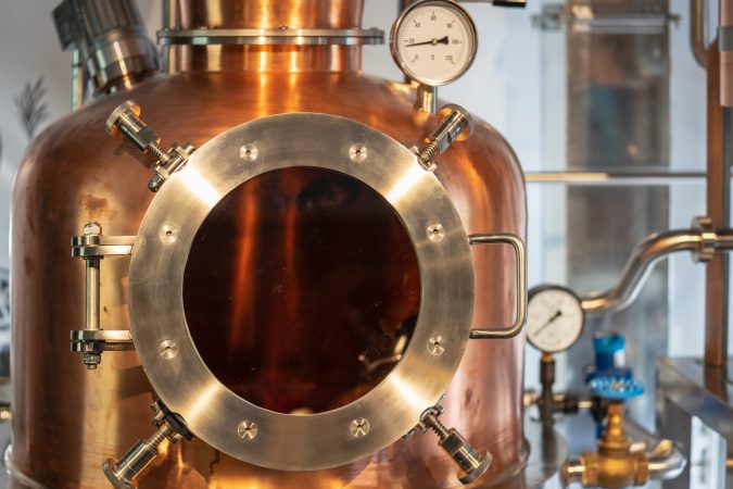 Copper vacuum still for distillation performed under reduced pressure for gin production.